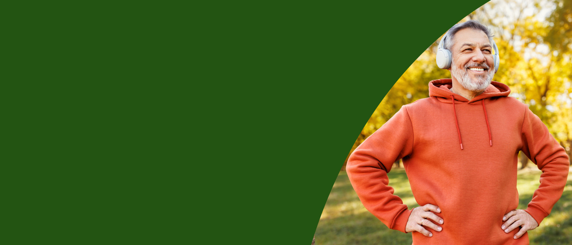 A smiling older man outdoors wearing a rust-orange pullover hoodie and white headphones, with a dark green graphic overlay on the left side.= desktop